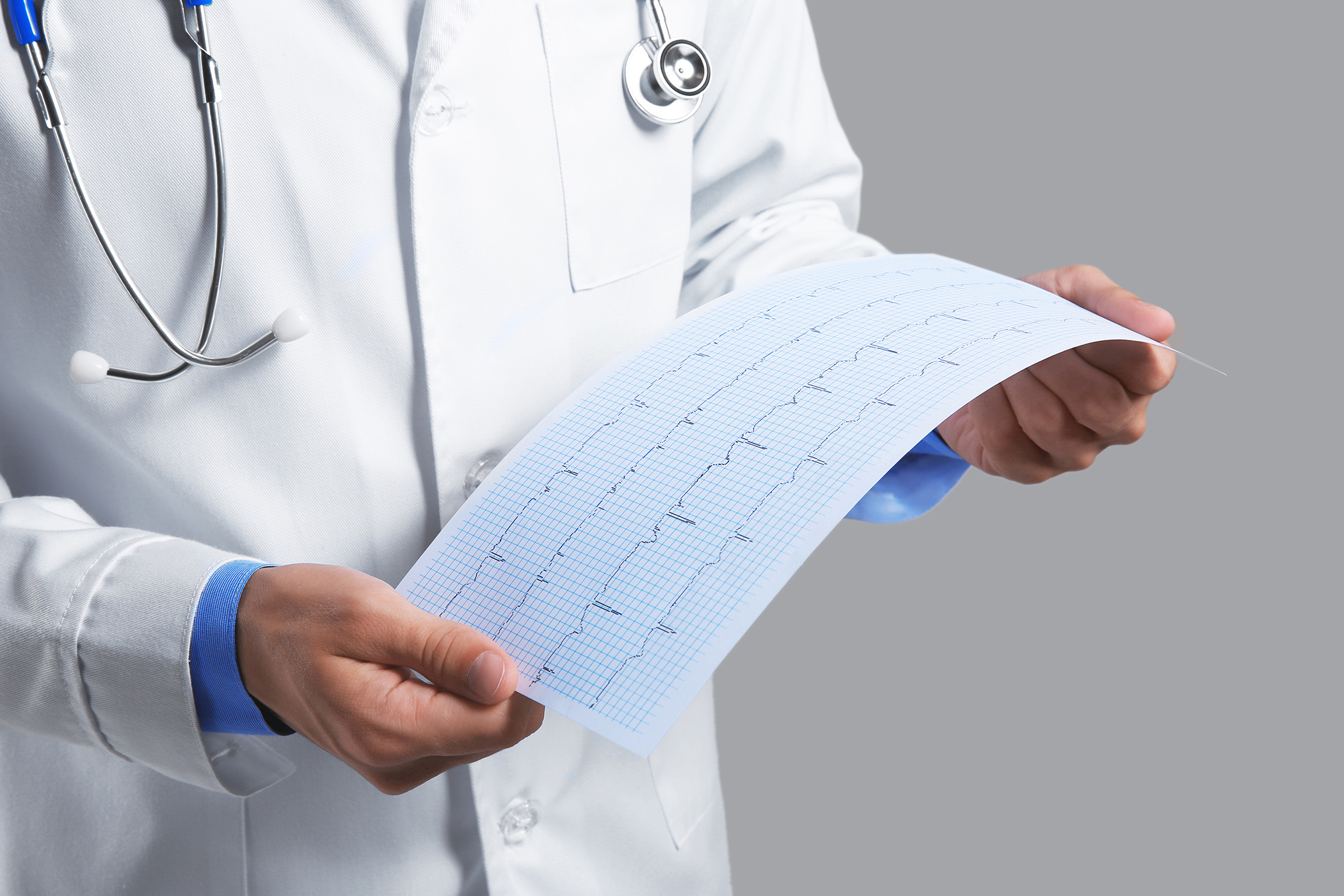 Male doctor with cardiogram paper, closeup